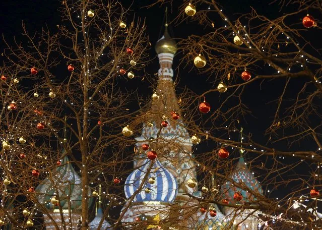 Trees are seen decorated with Christmas ornaments in Moscow's Red Square, with St. Basil's Cathedral seen in the background, Russia November 28, 2015. (Photo by Sergei Karpukhin/Reuters)