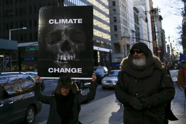 People take part in a protest about climate change around New York City Hall at lower Manhattan, New York, November 29, 2015, a day before the start of the Paris Climate Change Conference (COP21). (Photo by Eduardo Munoz/Reuters)