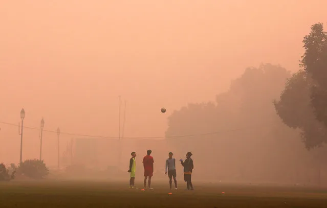 Boys play football in a public park on a smoggy morning in New Delhi, India, November 2, 2016. (Photo by Adnan Abidi/Reuters)