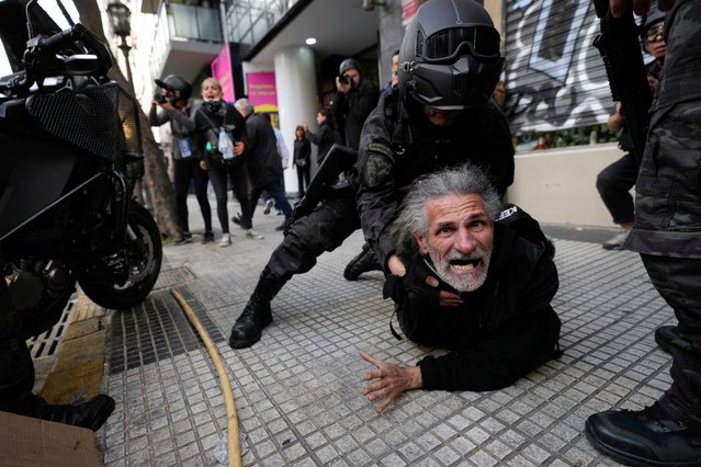 Police detain a protestor during a demonstration against President Javier Milei's veto of a pension raise in front of Congress in Buenos Aires, Argentina, Wednesday, September 11, 2024. (Photo by Rodrigo Abd/AP Photo)