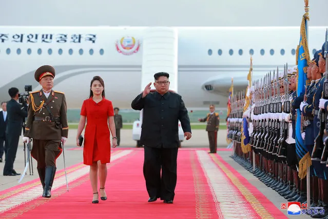 In this Wednesday, June 20, 2018, photo provided on Thursday, June 21, 2018, by the North Korean government, North Korean leader Kim Jong Un, center, and his wife Ri Sol Ju arrive at Pyongyang International Airport in Pyongyang, North Korea, after returning from China. Korean language watermark on image as provided by source reads: “KCNA” which is the abbreviation for Korean Central News Agency. (Photo by Korean Central News Agency/Korea News Service via AP Photo)