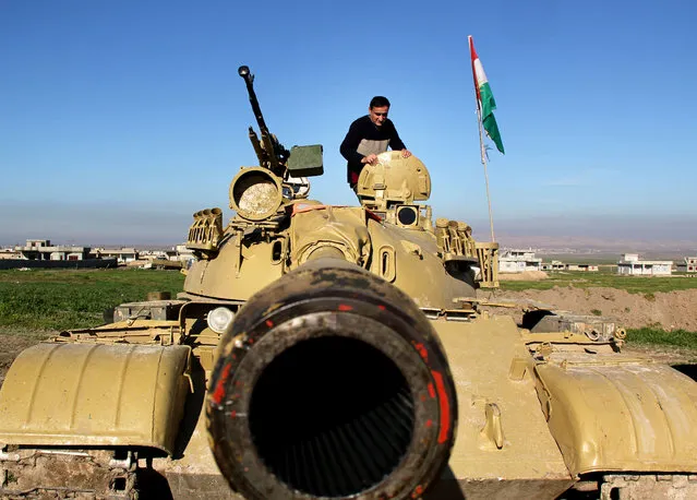 In this Tuesday, January 20, 2015 image released by the Kurdistan Region Security Council (KRSC), A Kurdish peshmerga stands on a military tank preparing for battle against the Islamic State group in northern Iraq. Kurdish Regional Security Council said Wednesday, Jan. 21, 2015 that Kurdish peshmerga fighters launched a new offensive to secure areas southeast and southwest of the dam. (Photo by AP Photo/Kurdistan Region Security Council)