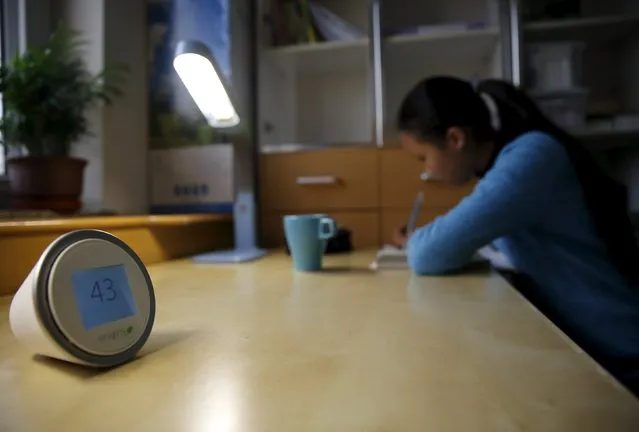 A portable device measuring air quality is placed on a desk while Jiang Zhen's daughter Dudu does her homework in her room, on the second day after China's capital Beijing issued its second ever “red alert” for air pollution, in Beijing, China, December 20, 2015. (Photo by Kim Kyung-Hoon/Reuters)