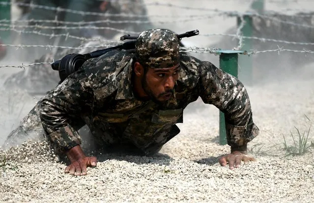 An Iranian marine competes during an obstacle course of the Seaborne Assault contest as part of the International Army Games 2018 on July 30, 2018 in Quanzhou, Fujian Province of China. (Photo by Wang Dongming/China News Service/VCG via Getty Images)