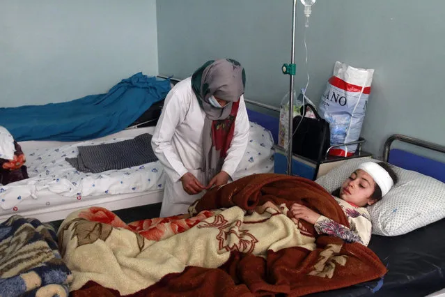 An injured girl is treated at a hospital after a car bomb attack in Herat province, west of Kabul, Afghanistan, Saturday, March 13, 2021. A powerful car bomb killed at least eight people and injured 47 in Afghanistan's western Herat province, officials said Saturday. (Photo by Hamed Sarfarazi/AP Photo)