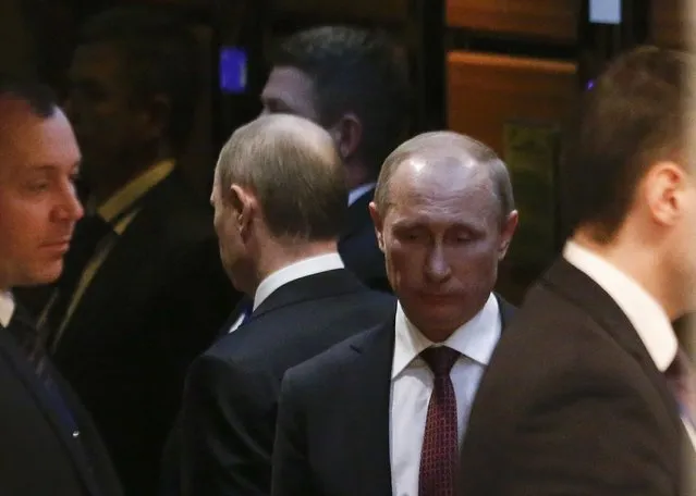 Russia's President Vladimir Putin (2nd R) uses an elevator as he attends a peace summit to resolve the Ukrainian crisis in Minsk, February 12, 2015. (Photo by Vasily Fedosenko/Reuters)