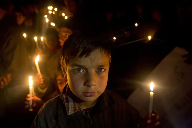 Kashmiri Shiite Muslim boys hold candles during a protest against Saudi Arabia in Srinagar, Indian controlled Kashmir, Tuesday, January 5, 2016. Hundreds of Shiite Muslim in Indian portion of Kashmiri rallied in the Shia dominated areas protesting against Saudi Arabia , after they announced on Saturday it had executed 47 prisoners convicted of terrorism charges, including al-Qaida detainees and a prominent Shiite cleric who rallied protests against the government. (Photo by Dar Yasin/AP Photo)