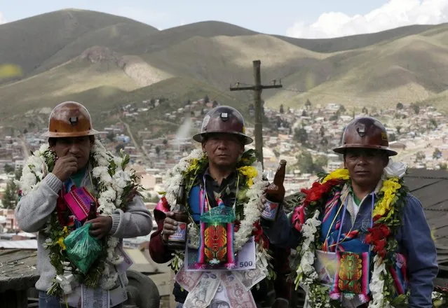 Independent mine workers hold bottles of beer during a celebration at the Itos (Nueva San Jose) silver and base metals mine during a celebration in the outskirts of Oruro, February 13, 2015. (Photo by David Mercado/Reuters)