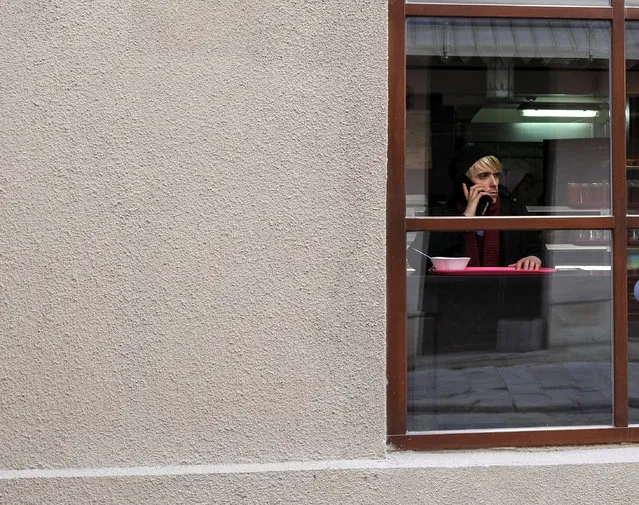 A man uses a mobile device as he rests in a cafe in central Lviv, Ukraine, November 24, 2016. (Photo by Gleb Garanich/Reuters)