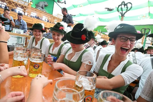 Visitors celebrate the world's largest beer festival, the 188th Oktoberfest, in Munich, Germany on September 17, 2023. (Photo by Angelika Warmuth/Reuters)