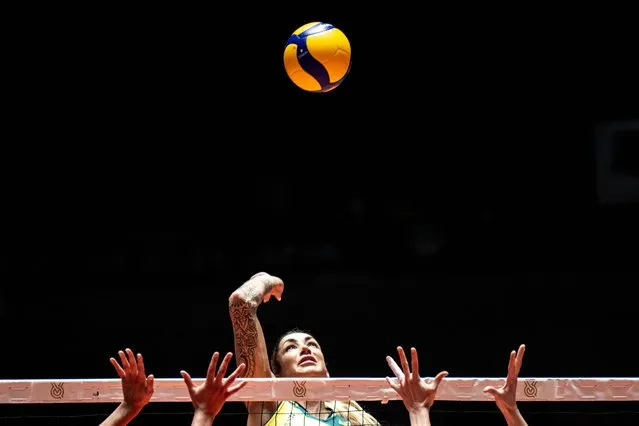 Brazil's Thaisa Daher de Menezes spikes the ball past Argentina's Daniela Bulaich Simian (L) and Brenda Graff (R) during the Volleyball World Cup 2023 Women's match between Brazil and Argentina at Yoyogi National Stadium in Tokyo on September 16, 2023. (Photo by Philip Fong/AFP Photo)