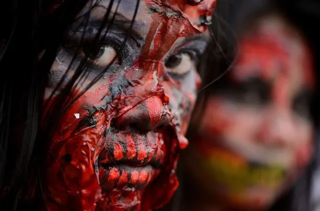 Students dressed as zombies participate in an annual Halloween Costume Parade in Manila on October 30, 2013. The activity aims to celebrate Halloween in a creative and fun way through the showcase of scary costumes. (Photo by Noel Celis/AFP Photo)