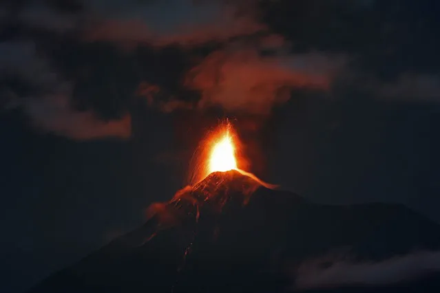 In this image taken with a long exposure, the Volcan de Fuego, or Volcano of Fire, spews hot molten lava from its crater in Antigua, Guatemala, early Monday, November 19, 2018. Disaster coordination authorities have asked eight communities in Guatemala to evacuate and go to safe areas after an increased eruption of the Volcano of Fire. (Photo by Moises Castillo/AP Photo)