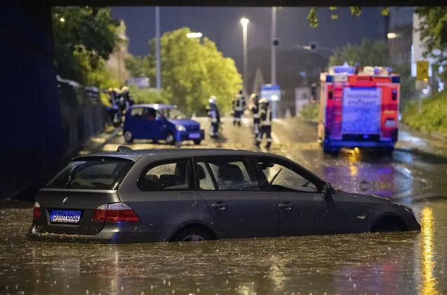 A car stands in the flooded car underpass in Stuttgart, Germany, Monday, June 28, 2021. Thunderstorms hit Germany late Monday and torrential rains poured down on the southern and western parts of the country leading to dozens of accidents and hundreds of firefighter operations throughout the night. (Photo by Marijan Murat/dpa via AP Photo)