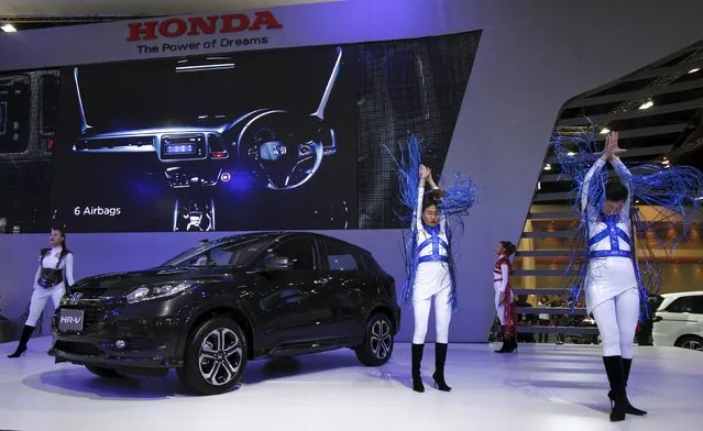 Models dance beside a HR-V during a media presentation of the 36th Bangkok International Motor Show in Bangkok March 24, 2015. (Photo by Chaiwat Subprasom/Reuters)