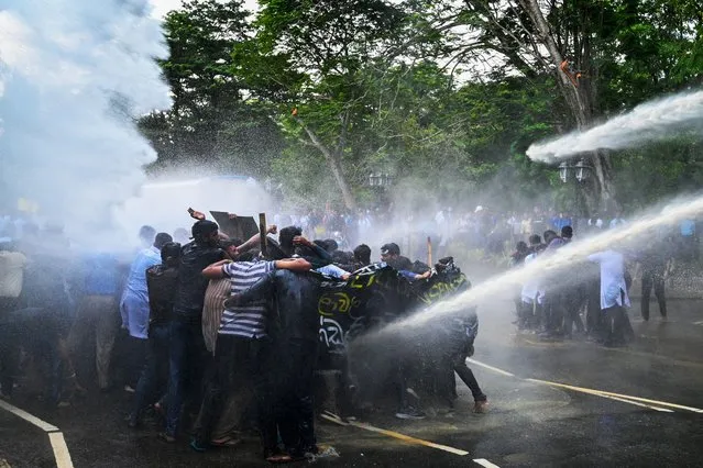 Police use water cannons to disperse university students demanding the closing of private medical universities during an anti-government demonstration in Colombo on October 27, 2023. (Photo by Ishara S. Kodikara/AFP Photo)