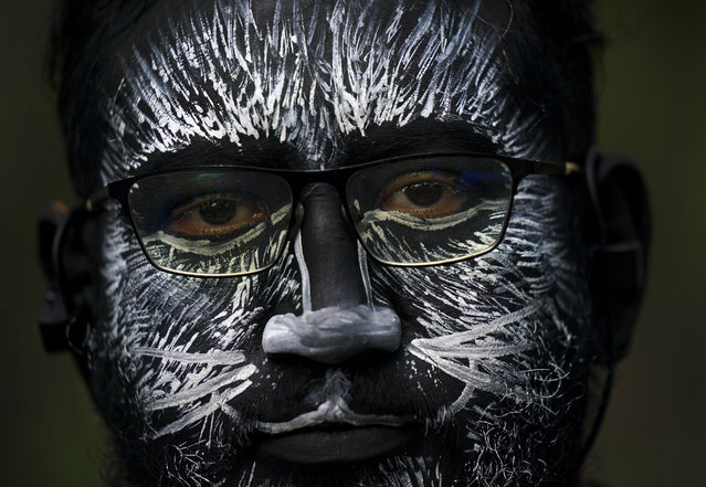 A visitor, his face painted to represent a zebra, eyes the camera during a parade marking the 100th anniversary of the Chapultepec Zoo, in Mexico City, Thursday, July 6, 2023. Zoo organizers invited visitors to come dressed as their favorite animal. (Photo by Fernando Llano/AP Photo)