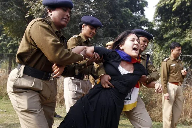 A Tibetan exile is detained by police during a protest over China's rule over Tibet, outside the Chinese embassy in New Delhi, on December 9, 2013. (Photo by Anindito Mukherjee/Reuters)