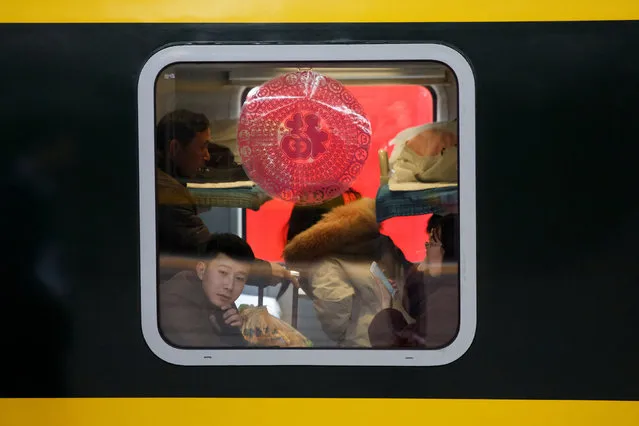 Travellers sit in a train at Beijing Railway Station during the annual Spring Festival travel rush ahead of the Chinese Lunar New Year, China, January 31, 2019. (Photo by Thomas Peter/Reuters)