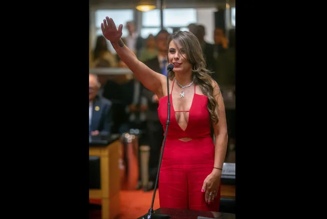 In this February 1, 2019 handout photo provided by the Santa Catarina Legislative Assembly Press Office office, State Rep. Ana Paula da Silva takes the oath of office in the Chamber of Deputies in Santa Catarina, Brazil. What da Silva chose to wear to the inauguration ceremony has led thousands of men and women to take to Twitter, Instagram and other social media. Detractors argue that she crossed a line, while others say clothes shouldn’t matter and asked politicians to focus on more pressing issues. (Photo by Luis Gustavo/Santa Catarina Legislative Assembly Press Office via AP Photo)