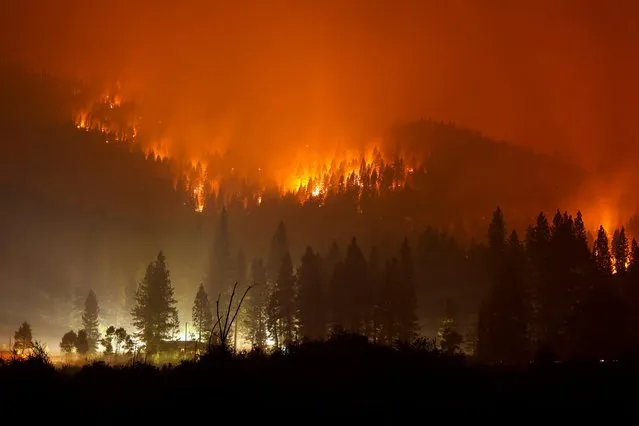 The Dixie Fire, now over 200,000 acres, burns at night in Taylorsville, California, U.S., July 27, 2021. (Photo by David Swanson/Reuters)