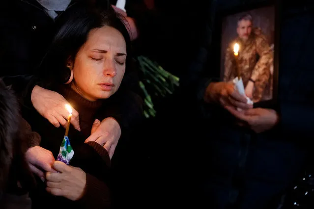 Olha reacts during a funeral ceremony for her husband Volodymyr Yezhov, Ukrainian serviceman and game designer for world renowned games S.T.A.L.K.E.R. and Cossacks, who was recently killed in a fight against Russian troops near the town of Bakhmut, amid Russia's attack on Ukraine, in Kyiv, Ukraine December 27, 2022. (Photo by Valentyn Ogirenko/Reuters)