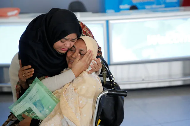A woman greets her mother after she arrived from Dubai on Emirates Flight 203 at John F. Kennedy International Airport in Queens, New York, U.S., January 28, 2017. (Photo by Andrew Kelly/Reuters)