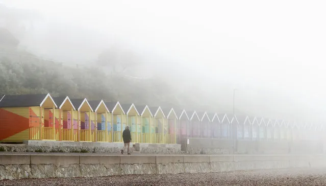 A lady walks along the promenade during a foggy morning in Folkestone, Kent, United Kingdom on Monday, June 7, 2021. (Photo by Gareth Fuller/PA Images via Getty Images)