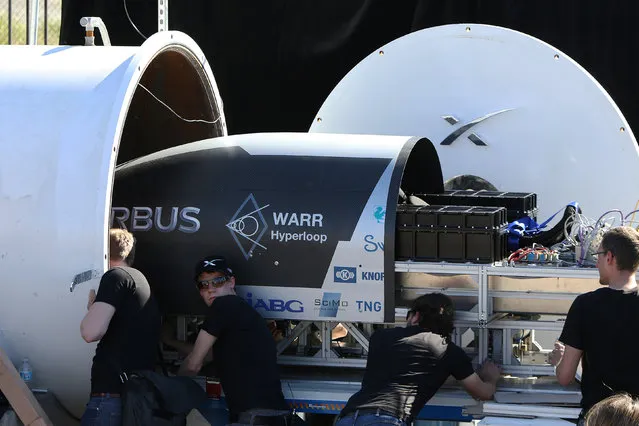 Team members from WARR Hyderloop, Technical University of Munich place their pod on the track during the SpaceX Hyperloop Pod Competition in Hawthorne, Los Angeles, California, U.S., January 29, 2017. (Photo by Monica Almeida/Reuters)