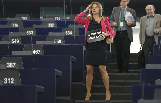 Slovakia's Member of the European Parliament Monika Flasikova Benova holds a leaflet with the slogan “I am a migrant” as she arrives to  attend a debate on the latest tragedies in the Mediterranean and E.U. migration and asylum policies at the European Parliament in Strasbourg, France, April 29, 2015. (Photo by Vincent Kessler/Reuters)
