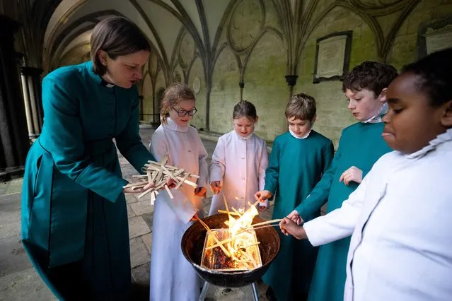 Canon Anna Macham, Canon Precentor, supervises choristers during the burning of palm crosses to make ash for Ash Wednesday at Salisbury Cathedral, on February 08, 2024 in Salisbury, England. Probationers, or trainee choristers, from Salisbury Cathedral spent the morning making and eating pancakes at the Canon Precentor’s house, a traditional chorister probationer event during which they learn about Shrove Tuesday and Lent and prepare the ash for Ash Wednesday services by burning palm crosses. (Photo by Finnbarr Webster/Getty Images)