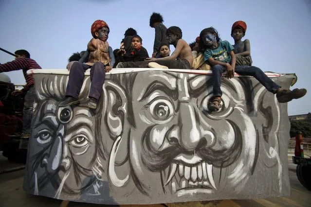 Young Hindu devotees dressed as demons participate in a procession on the eve of Shivratri festival, in Jammu, India, Wednesday, February 26, 2014. (Photo by Channi Anand/AP Photo)