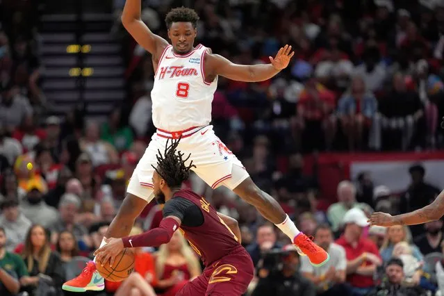 Houston Rockets' Jae'Sean Tate (8) defends against Cleveland Cavaliers' Darius Garland during the second half of an NBA basketball game Saturday, March 16, 2024, in Houston. The Rockets won 117-103. (Photo by David J. Phillip/AP Photo)