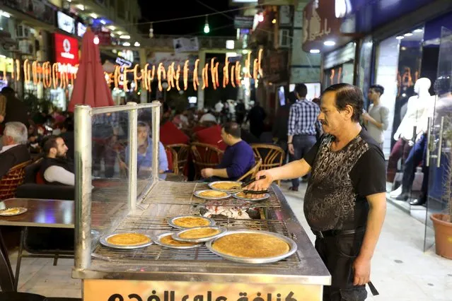 Syrians work at an eastern sweets restaurant in an area called 6 October City in Giza, Egypt, March 19, 2016. (Photo by Mohamed Abd El Ghany/Reuters)