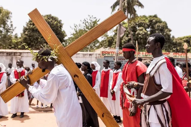 Gambian Christian worshippers reenact the Stations of the Cross which recalls the last stage of the journey that Jesus Christ travelled prior to his crucifixion, as people mark Good Friday, part of Easter celebrations in Bakote on March 29, 2024. (Photo by Muhamadou Bittaye/AFP Photo)