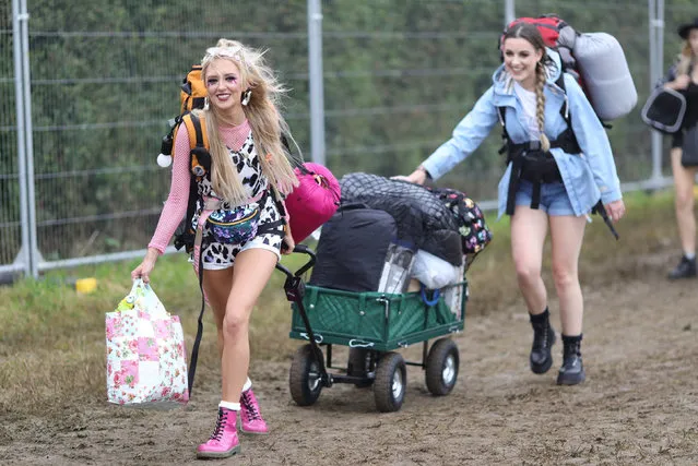 People arrive on the first day of the Glastonbury Festival at Worthy Farm in Somerset, Britain on June 26, 2019. (Photo by Aaron Chown/PA Images via Getty Images)