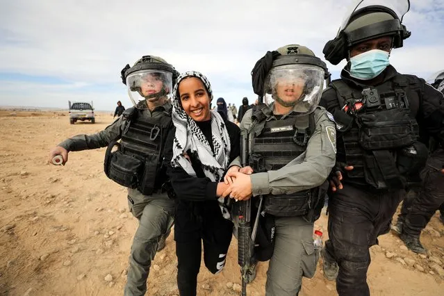 A Bedouin woman reacts as she is detained by Israeli security forces during a protest against forestation at the Negev desert village of Sawe al-Atrash, southern Israel January 12, 2022. (Photo by Ammar Awad/Reuters)