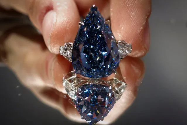 Rahul Kadakia, Head of Jewelry for Christie's Auction House holds “The Blue” diamond in New York, April 11, 2014. Christie's New York is displaying the largest flawless fancy vivid blue diamond ever to appear at auction. The diamond is pegged at $21 million to $25 million and is the highlight of an upcoming Magnifient Jewels sale in Geneva. (Photo by Carlo Allegri/Reuters)