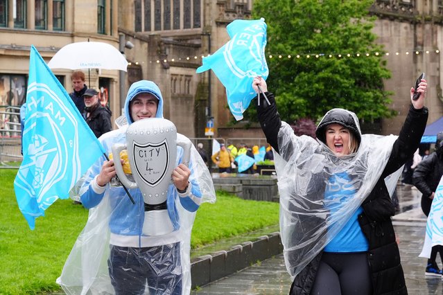 Manchester City fans wait in the rain in Cathedral Gardens ahead of a trophy parade in Manchester on Sunday, May 26, 2024, after they won their fourth successive Premier League title and their sixth in seven years. (Photo by Owen Humphreys/PA Images via Getty Images)