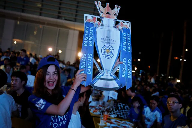 Leicester City fans celebrate after their team drew against Manchester United while watching the game on a big screen, in Bangkok, Thailand, May 1, 2016. (Photo by Jorge Silva/Reuters)