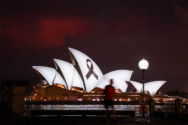 A black ribbon, symbolising remembrance and mourning, is projected onto the Sydney Opera House on February 9, 2023 in solidarity with Turkey and Syria after a massive earthquake devastated the two countries. (Photo by David Gray/AFP Photo)