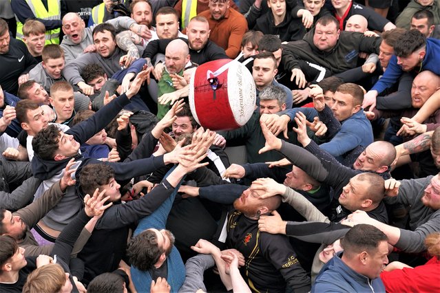 Players take part in the 823rd Atherstone Ball Game in Atherstone, Warwickshire, UK on Tuesday, February 21, 2023. The game honours a match played between Leicestershire and Warwickshire in 1199, when teams used a bag of gold as a ball, which was won by Warwickshire. (Photo by Joe Giddens/PA Images via Getty Images)