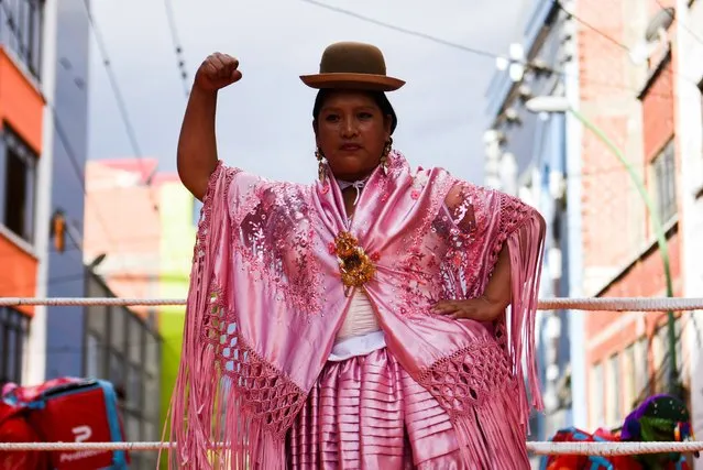 A Cholita wrestler gestures during a performance on the street during the Electropreste celebration, which combines traditional and modern customs, in La Paz, Bolivia on March 12, 2022. (Photo by Claudia Morales/Reuters)