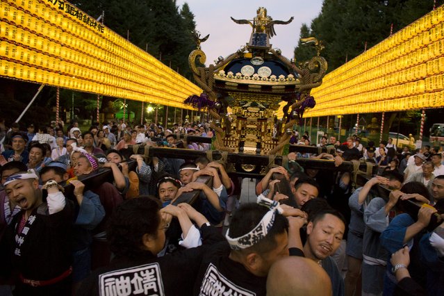People carry a portable shrine during the annual Mitama Festival at the Yasukuni Shrine in Tokyo, Japan, July 13, 2015. (Photo by Thomas Peter/Reuters)