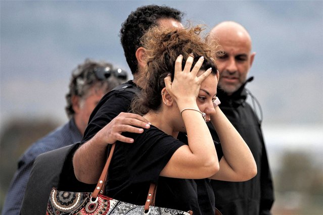A woman reacts as Greek nationals who have been evacuated from Sudan arrive at a military airport in Elefsina, Greece on April 25, 2023. (Photo by Alkis Konstantinidis/Reuters)