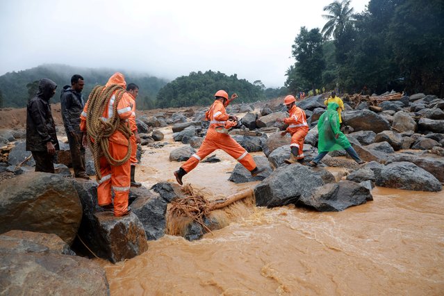 Members of rescue teams move towards a landslide site after multiple landslides in the hills in Wayanad, in the southern state of Kerala, India, on July 30, 2024. (Photo by Reuters/Stringer)