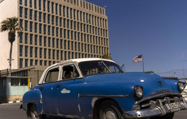 A classic American car drives past the United States Embassy, in Havana, Cuba, Thursday, March 3, 2022. Chargé d'affaire Timothy Zuniga-Brown announced on Thursday that the embassy is preparing for a gradual reopening of its consular services in Cuba. (Photo by Ramon Espinosa/AP Photo)