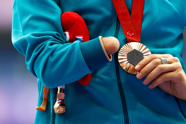 Bronze medallist Nikita Kotukov of Neutral Paralympic Athletes celebrates on the podium during the men's long jump t47 medal ceremony in Saint-Denis, France on September 3, 2024. (Photo by Carlos Garcia Rawlins/Reuters)