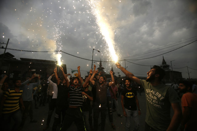Kashmiris light fire crackers as they celebrate India losing two early wickets during the Champions Trophy cricket final match between India and Pakistan, in Srinagar, Indian controlled Kashmir, Sunday, June 18, 2017. Later in the day Pakistan defeated India by 180 runs to lift the cup. (Photo by Mukhtar Khan/AP Photo)