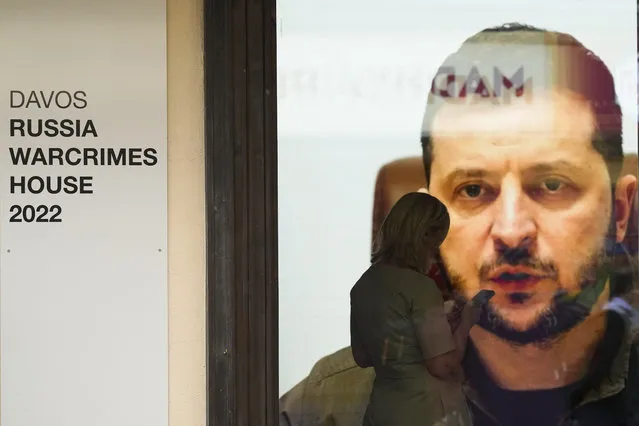 Ukrainian President Volodymyr Zelenskyy speaks on a screen inside a so-called Russian War Crimes House alongside the World Economy Forum in Davos, Switzerland, Sunday, May 22, 2022. (Photo by Markus Schreiber/AP Photo)